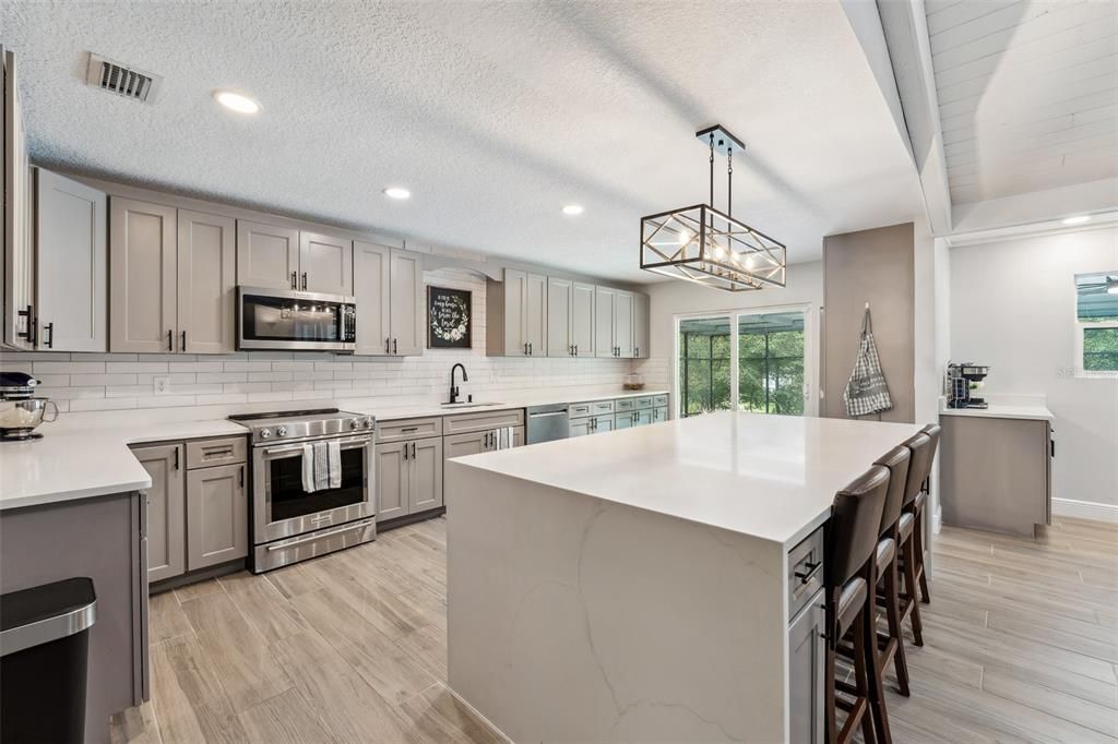 Oh My Goodness!!!! This kitchen is every chefs dream.  Featuring a 9x4 island with quartz countertops and beautiful cabinets and backsplash