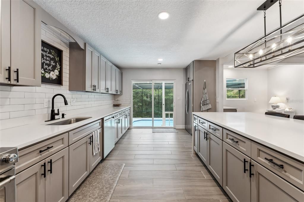 Huge long kitchen with a view of the pool