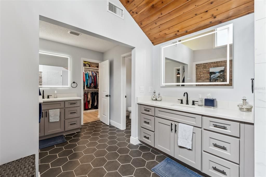 Ensuite with separate water room tha features a toilet and bidet