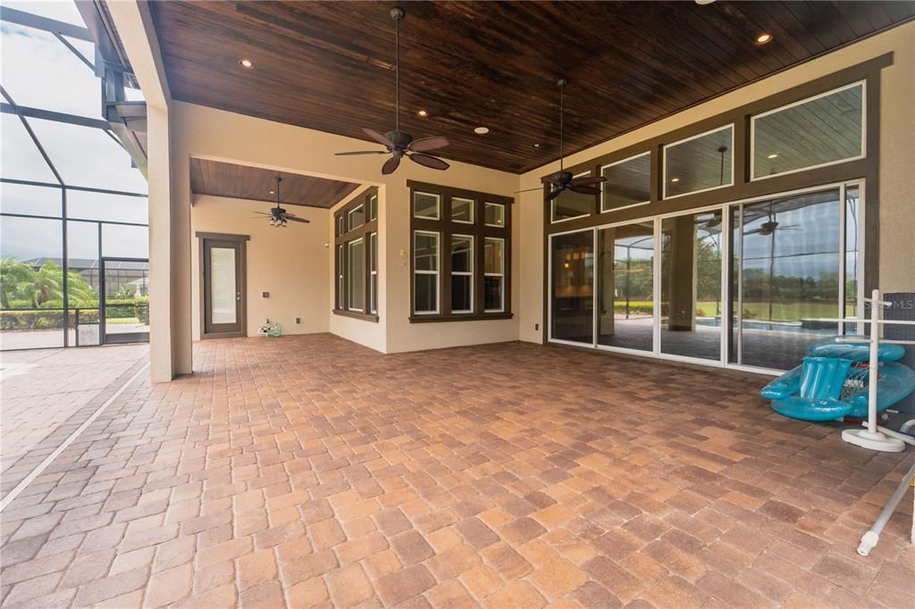 The large back porch with fans and an entrance to the master bedroom.