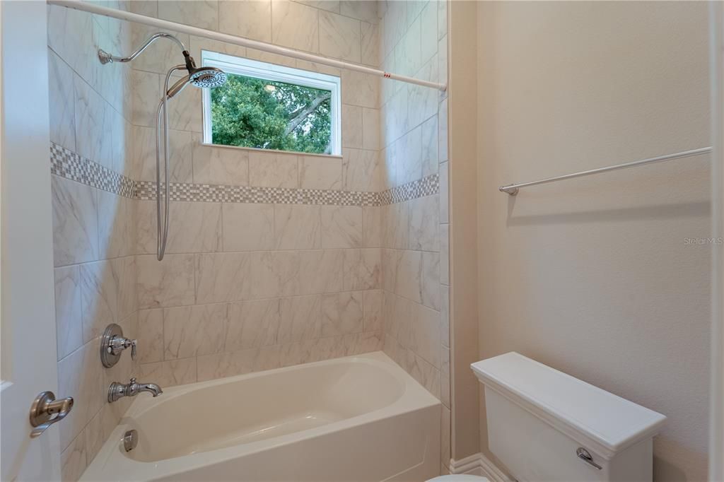 The shower area of the shared bathroom.