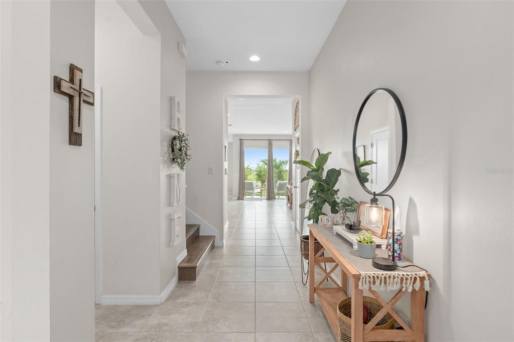 Entryway highlighting high ceilings and tile throughout first floor.