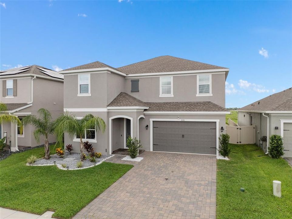 gorgeous front elevation with paver driveway and covered entrance. Home is 3 years new!