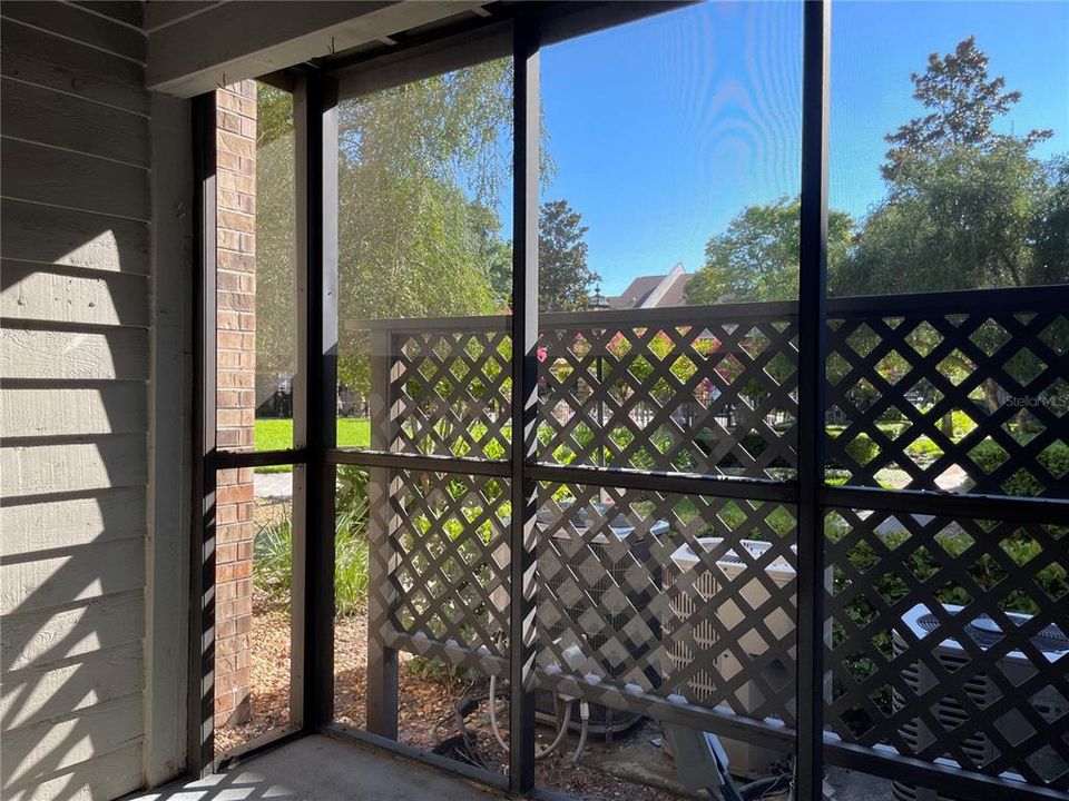 Screened rear porch with garden view