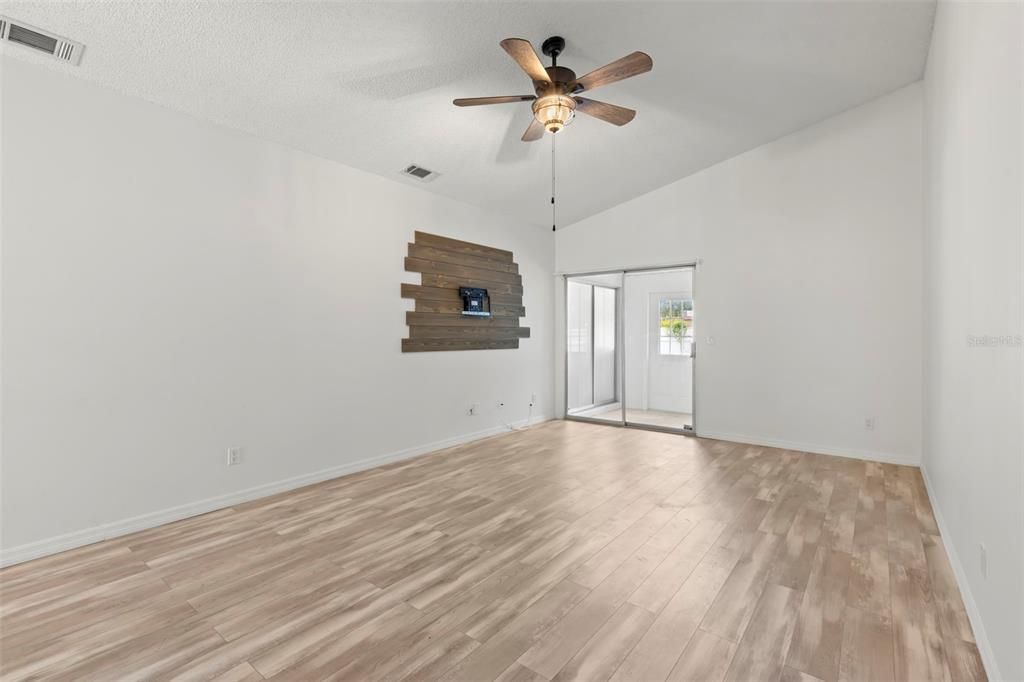 Family room with sliders to enclosed porch.