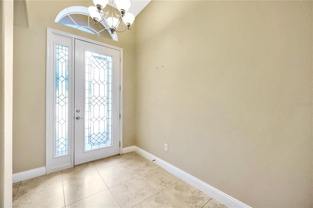 Oversized beveled glass door allows in plenty of natural light