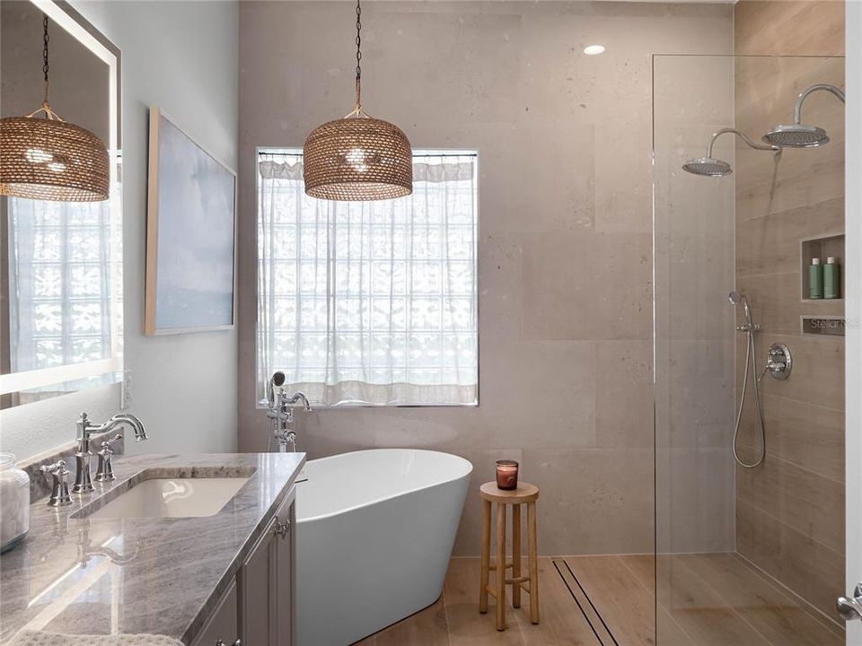 Primary Spa Bathroom with garden tub, double sink vanity, lighted mirror, and dual fixture walk-in shower.