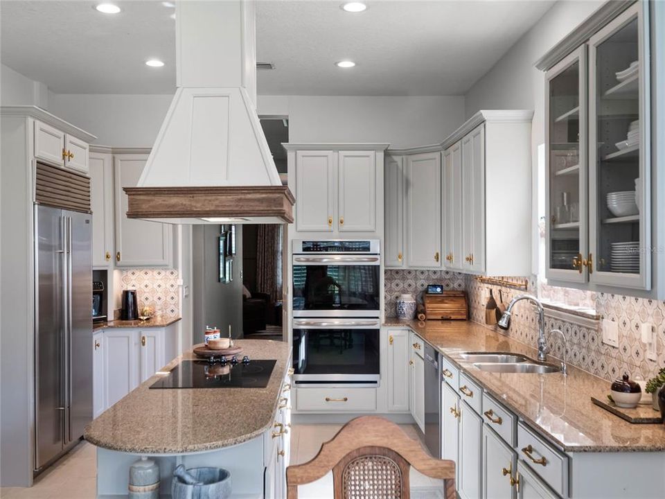Kitchen with designer tile, hardware, sub-zero refrigerator and walk-in pantry.