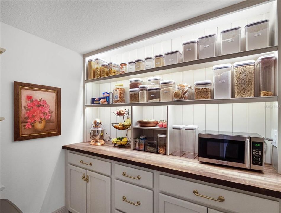 Custom Walk-in pantry with shelving, hardware and cabinetry.