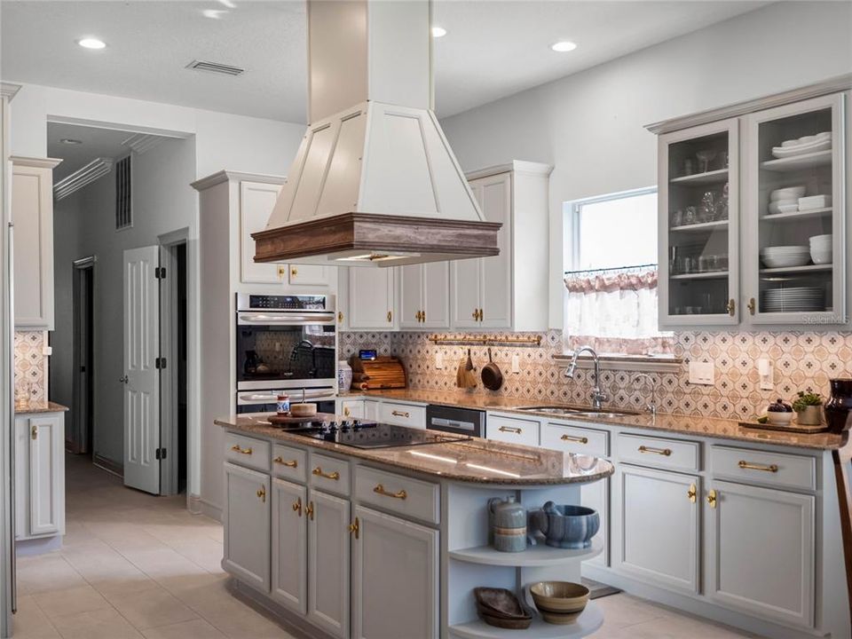 Kitchen with designer tile, hardware, sub-zero refrigerator and walk-in pantry.
