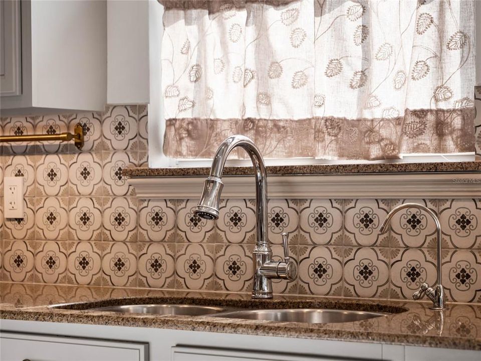 Designer backsplash and plumbing fixtures.