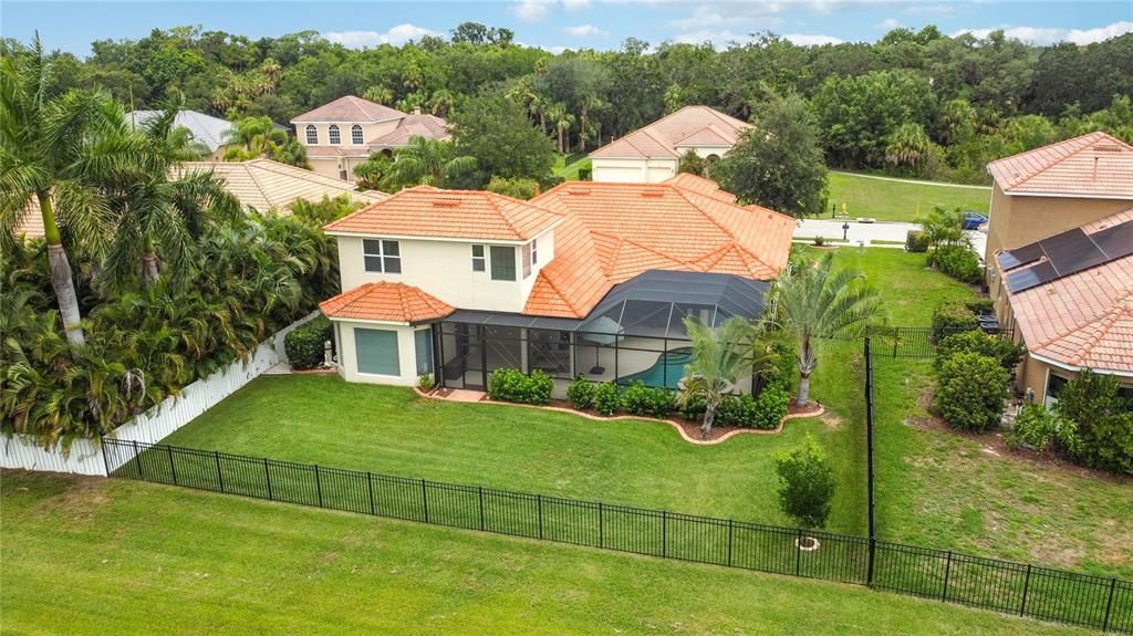 Heated saltwater pool and spa inside large screened in lanai with 2 large covered areas for dining, lounging poolside.