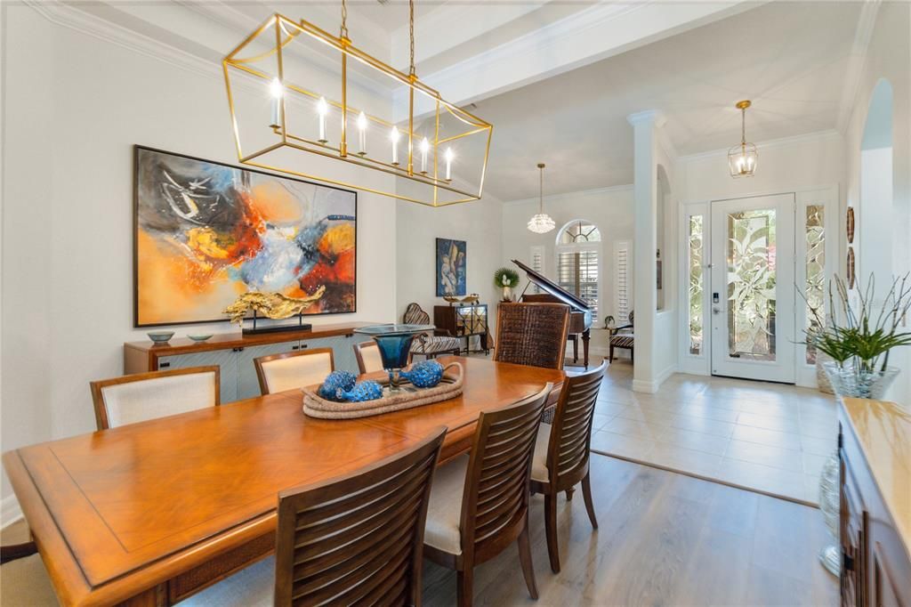 When first entering the home you are met with this cultivated, luxury designed formal dining room with high tray ceilings and sophisticated modern lighting. Luxury Vinyl plank flooring flows throughout the home.