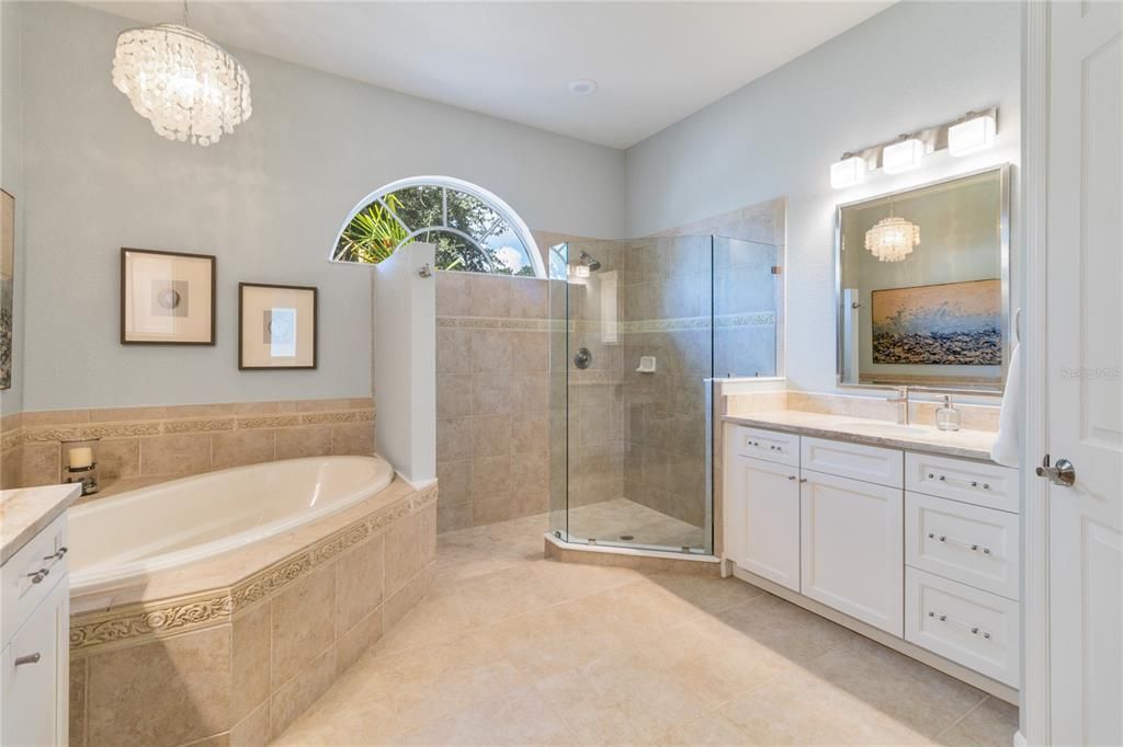 Take a relaxing shower in this walk in shower or take a bath in luxury inside the oversized soaking tub underneath this elegant chandelier so you always feel like you're at the spa.