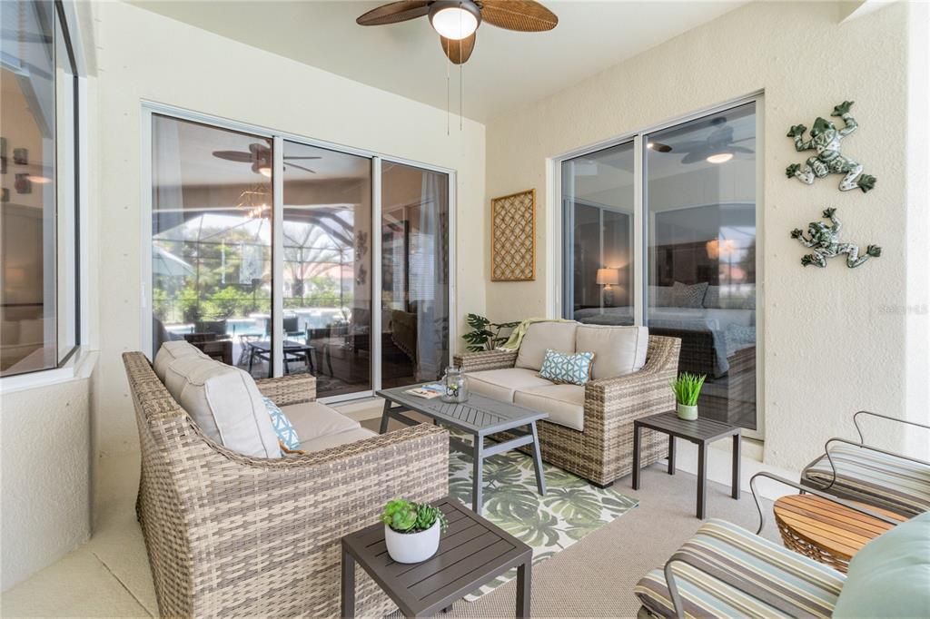 First of the two outdoor living space accessible through either dining room or primary bedroom. Stay cool under the ceiling fan while enjoying some down time with family and guests.
