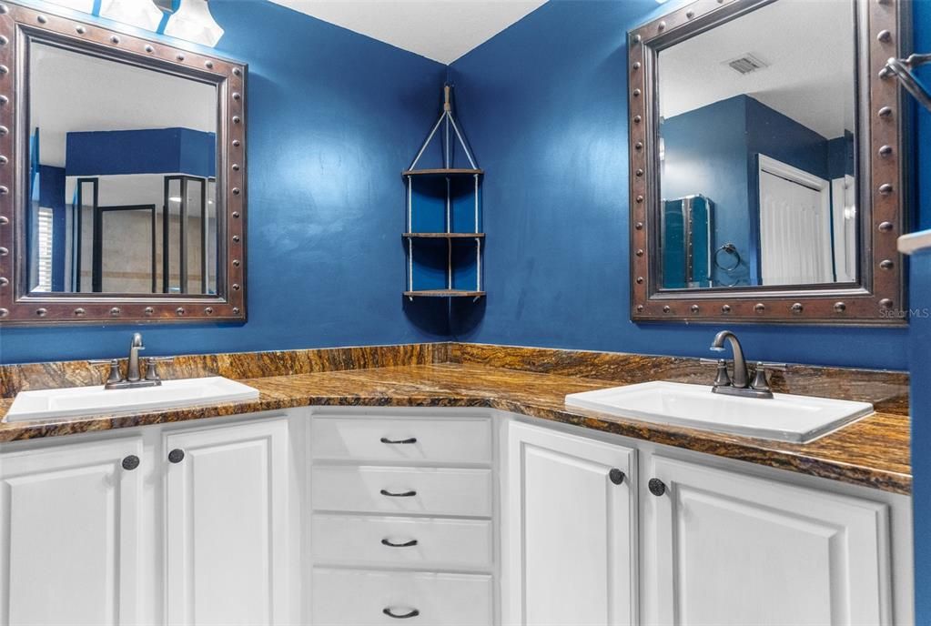 oversized dual sinks and high end granite counter tops.