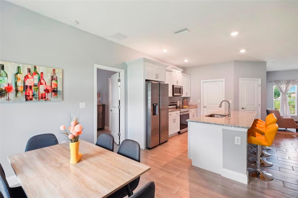 Kitchen view showing cabinets, appliances, facing laundry room.