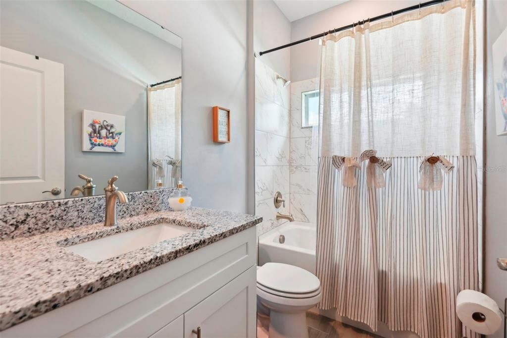 Primary en-suite bathroom with dual vanities.