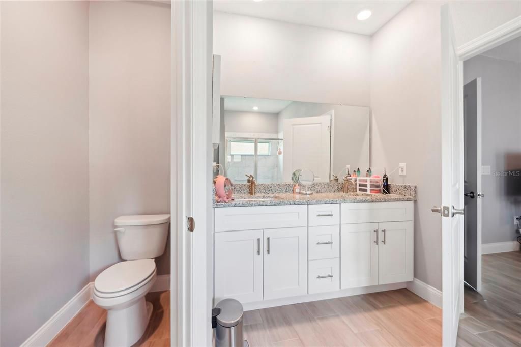 Laundry room showing included washer and dryer combo, and door to the garage.