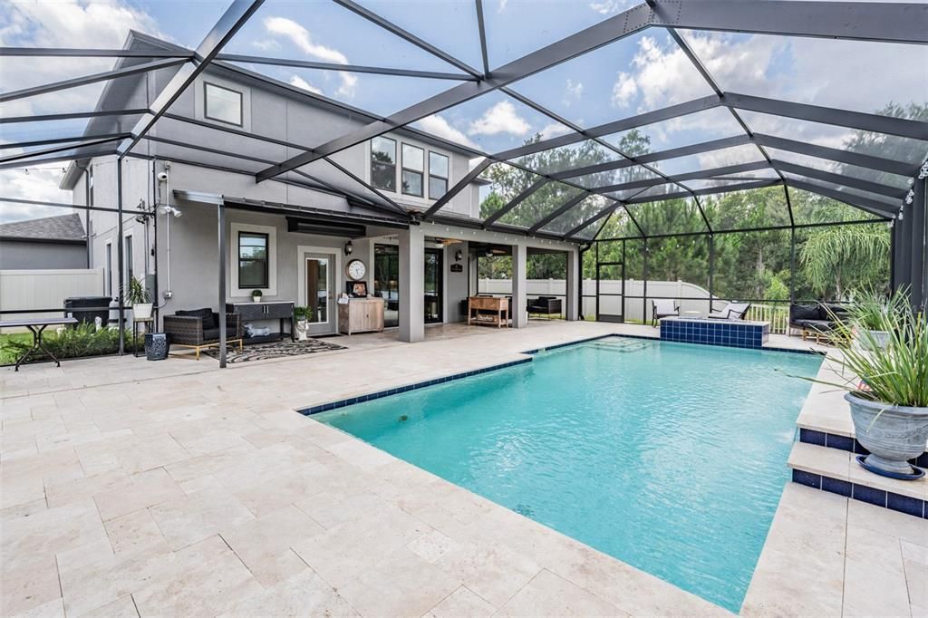 pool with propane fire pit and travertine pavers