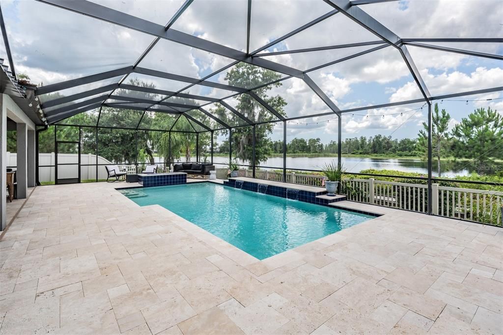 pool with propane fire pit and travertine pavers