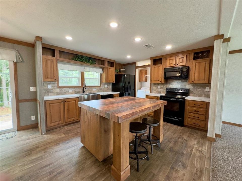 kitchen with farm sink, island breakfast bar (with cabinets)