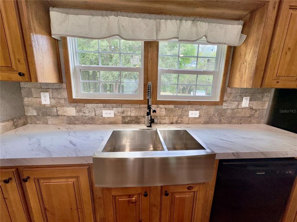 fantastic veiw of back yard over farm sink