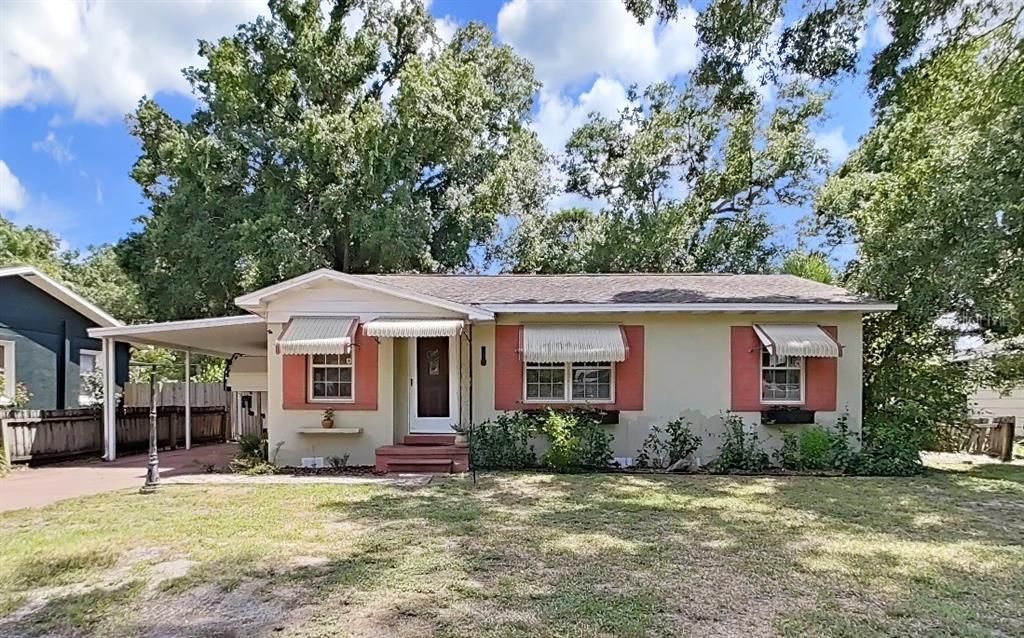 Large front yard and a covered Carport.