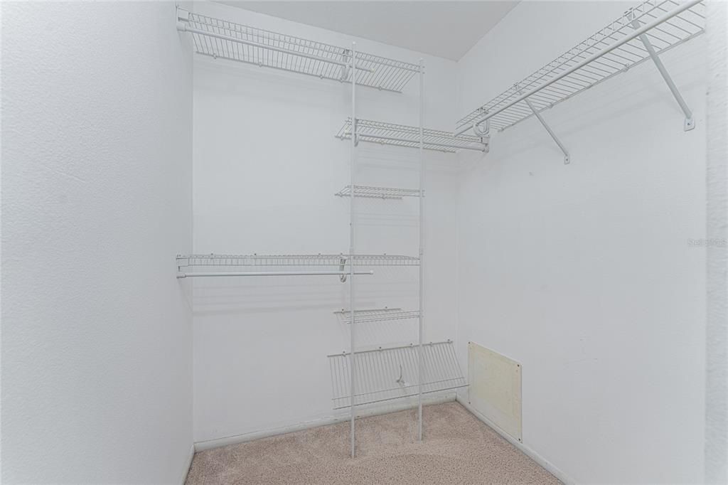 Primary bedroom walk-in closet