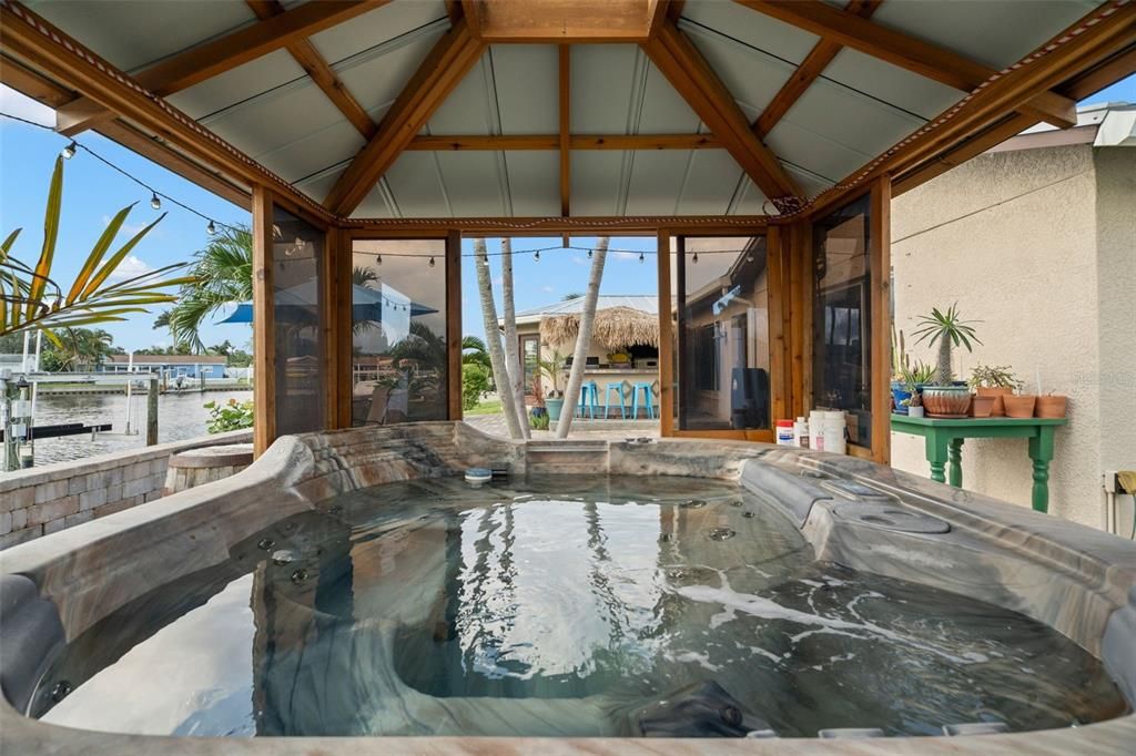 Spa surrounding windows open with View of Water and Tiki Bar