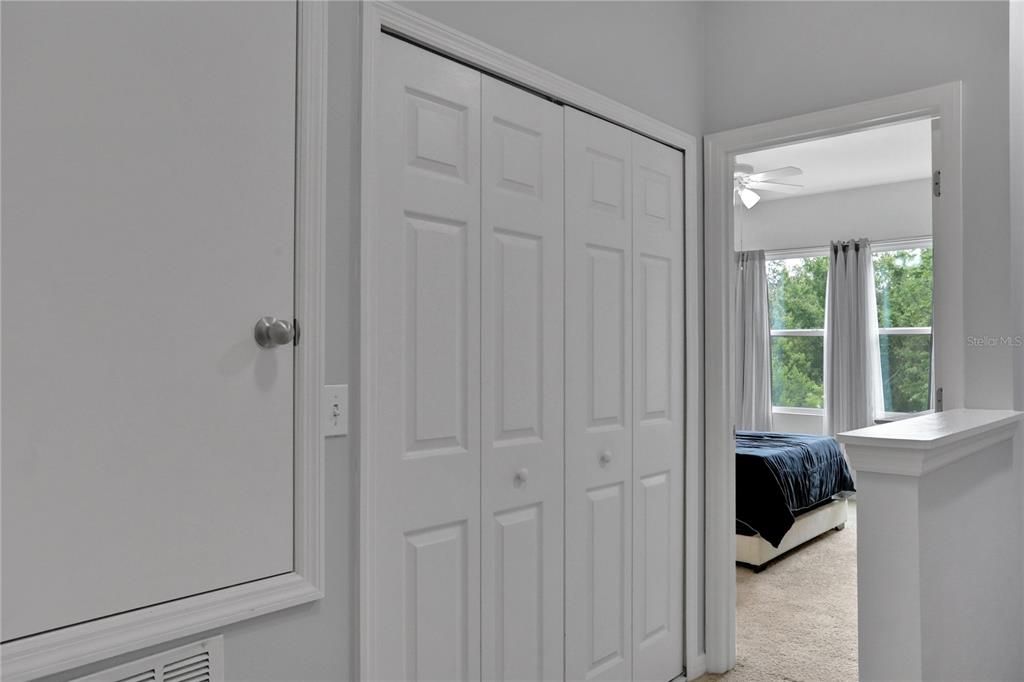 Up the stairs to the right, entrance to primary bedroom. Double doors lead to laundry closet.