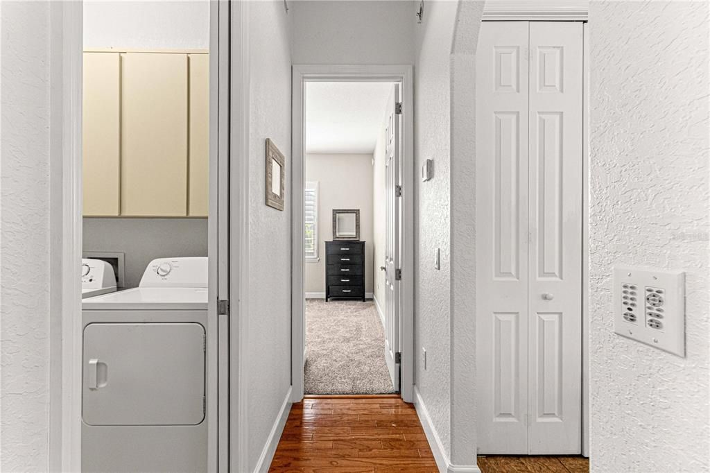 Hallway Leading to Laundry Room, Guest Bedroom 1, and Kitchen