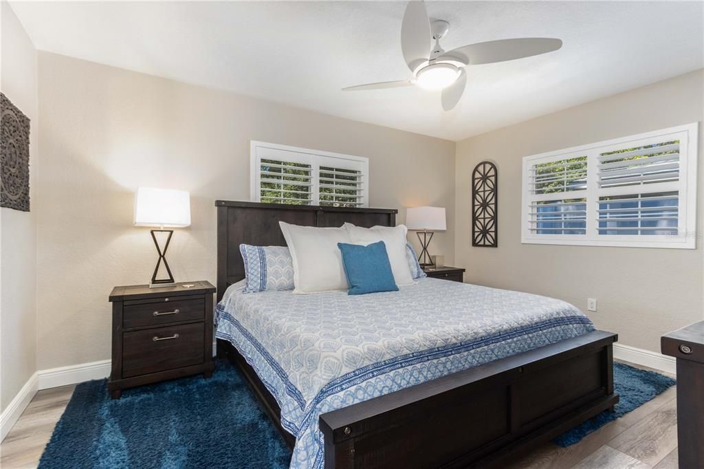 Primary Bedroom with shutters and ceiling fan