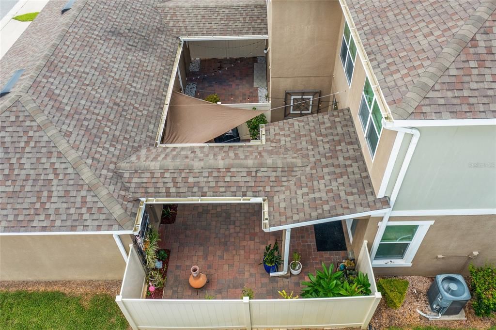 Covered walkway between the home and the garage.