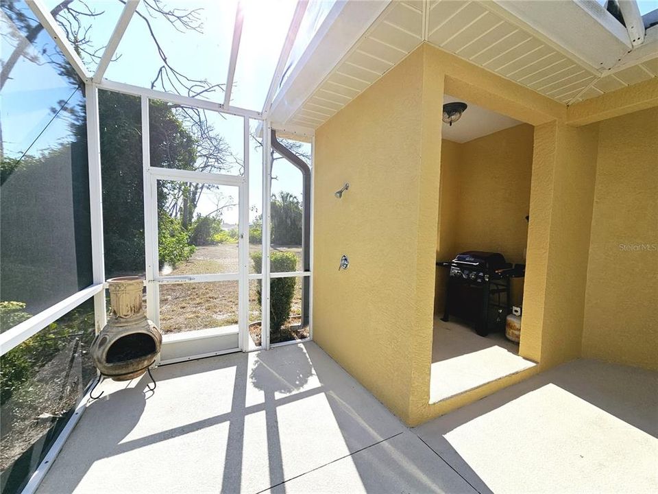 Screened lanai with outside shower and BBQ area