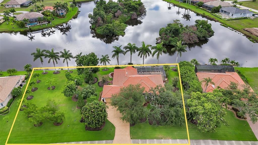 Three lake-front lots lined with Royal Palms