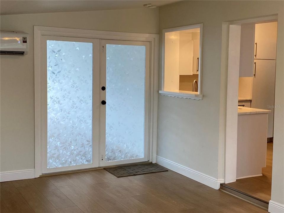 Living Room # 2 dual frosted doors and kitchen pass through