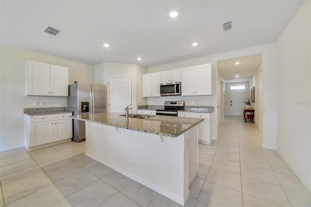 This light and bright OPEN CONCEPT layout features a modern kitchen complete with STAINLESS STEEL APPLIANCES, dining area with sliding glass door access to the COVERED LANAI and a spacious living room to gather with family and entertain friends.