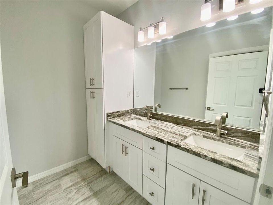 primary in suite bath, double vanity, granite, storage cabinet