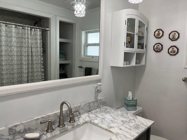 Hall bathroom with granite countertops
