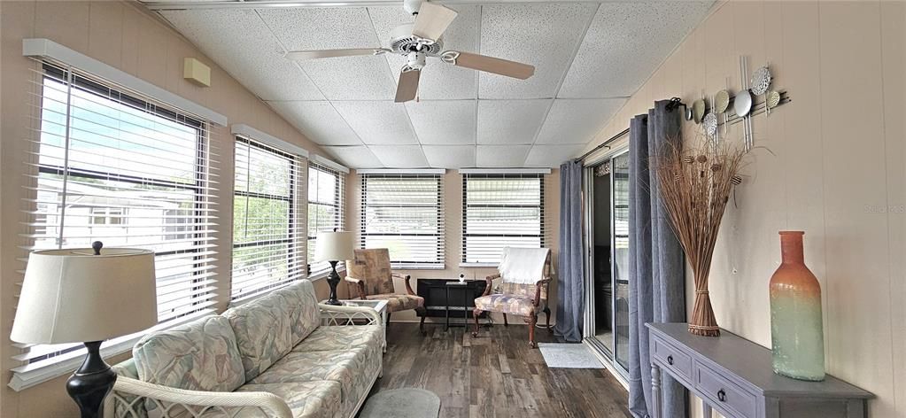 Florida room includes ceiling fan & electric fireplace