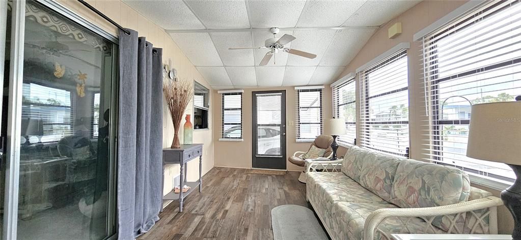 Florida room includes ceiling fan & electric fireplace