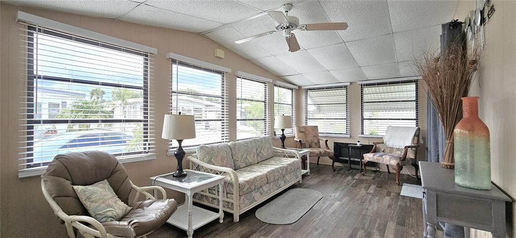 Florida room includes ceiling fan & electric fireplace