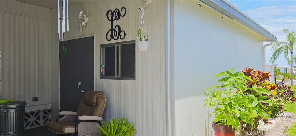 Storage/Utility room includes rear & front entry, windows, electricity, ceiling fan, washer/dryer, shelves, workbench, electric water heater, washer, dryer, utility sink