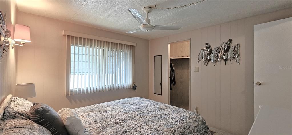 Guest bedroom includes ceiling fan & walk-in closet