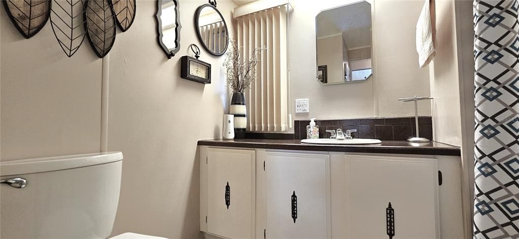 Guest bathroom includes tub & shower combo