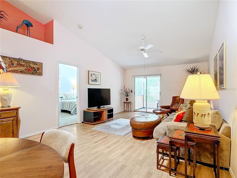 View of living area from dining area, note vault ceilings