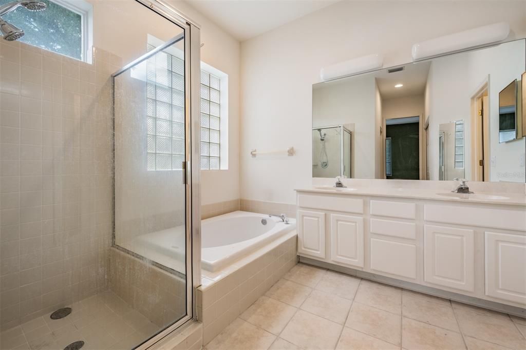 Masster Bathroom, tile flooring, double vanities, separate shower and tub.