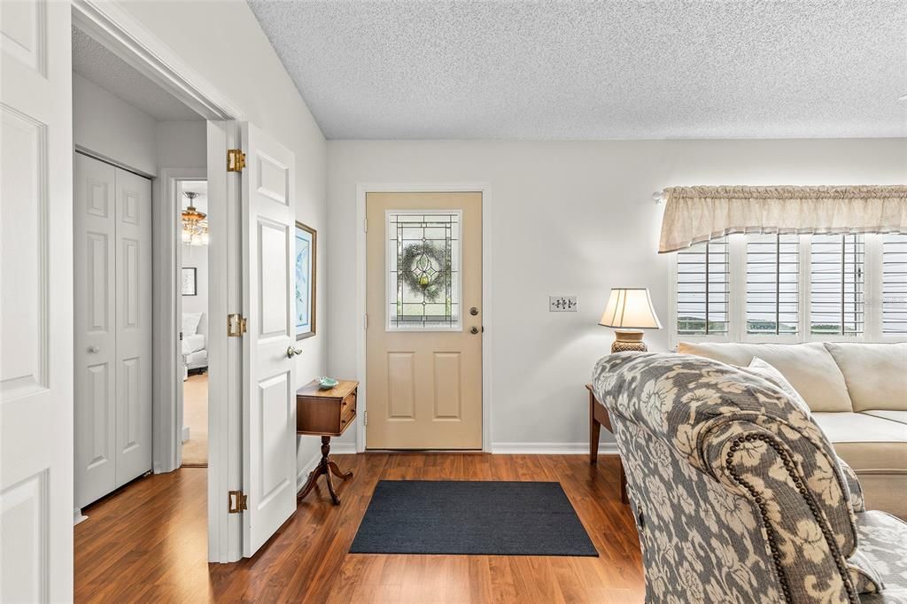 Front door with living room to right, guest bedrooms and bath to left of photo. Double doors for privacy.