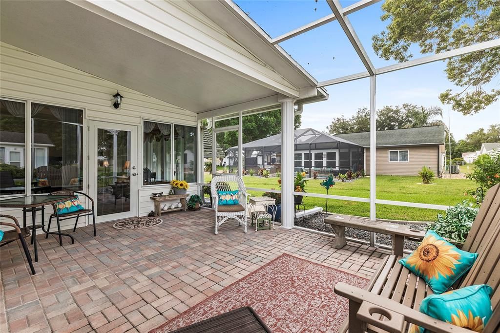 Screened room off Florida room with brick paver flooring.